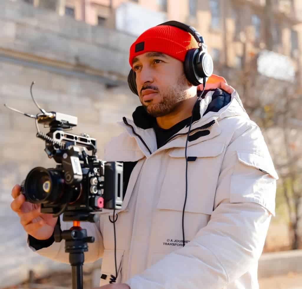 videographer with lavalier receiver on video camera 